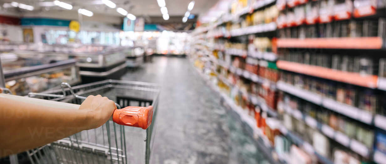 closeup-of-woman-with-shopping-cart-at-grocery-store-woman-pushing-shopping-cart-in-supermarket-JLPSF11876